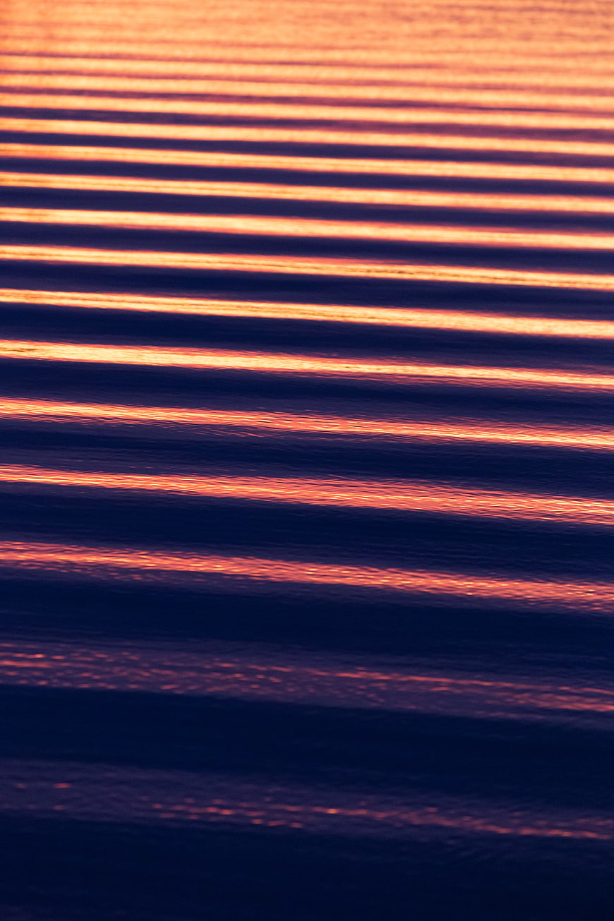 Abstract Sunset Reflections on Rippled Water Surface