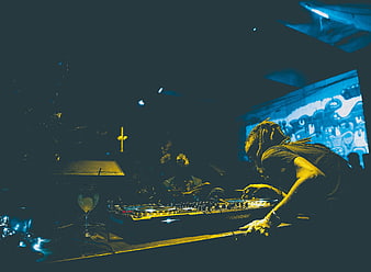 DJ Mixing Music in Dark Club with Neon Lights
