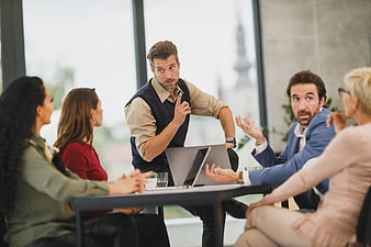 Diverse business team discussing strategy in modern office meeting