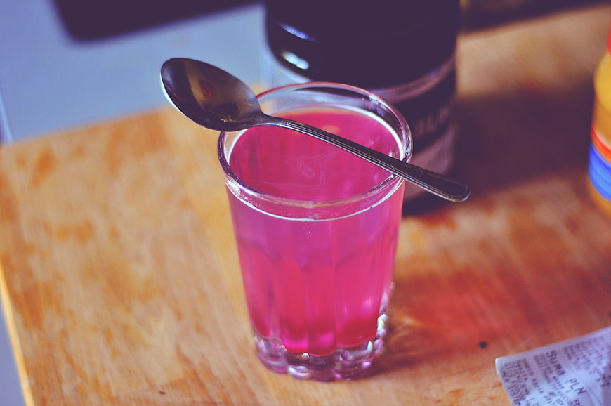 Pink Drink in Glass with Spoon on Wooden Table