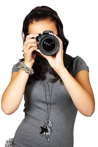 Woman holding DSLR camera to face on white background