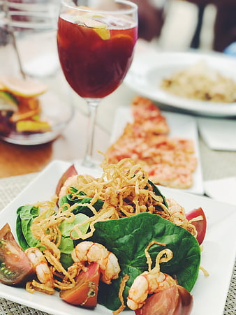 Shrimp spinach salad with sangria on restaurant table