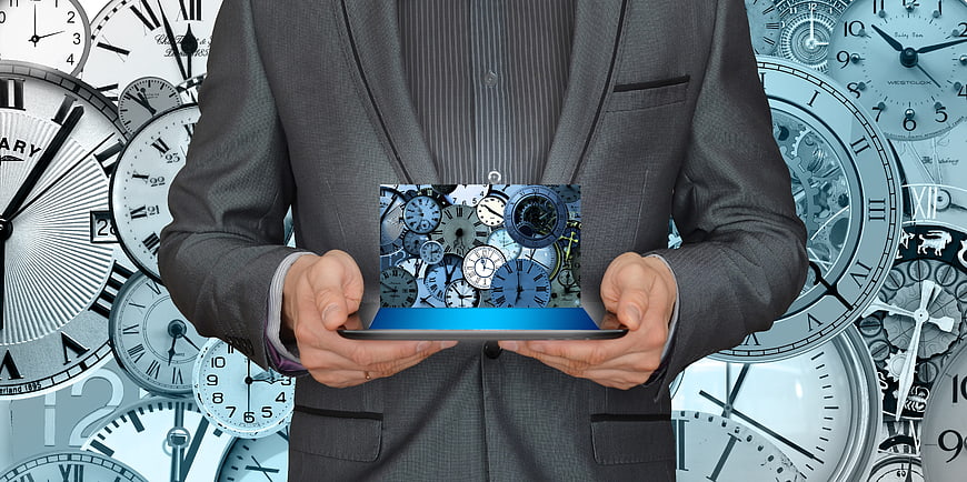 Businessman holding tablet with clock collage background