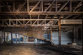 Abandoned industrial interior with rusty steel beams and decay