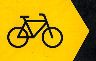Yellow bicycle traffic sign with directional arrow