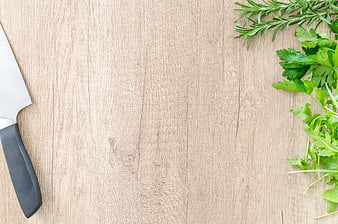 Fresh Herbs and Chef Knife on Wooden Cutting Board Background