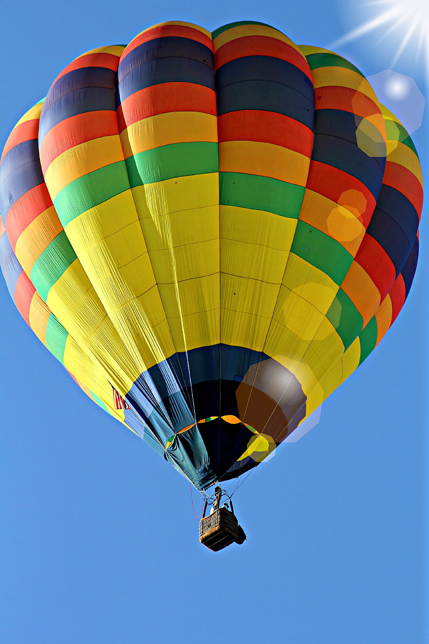 Colorful Hot Air Balloon Flying Against Blue Sky