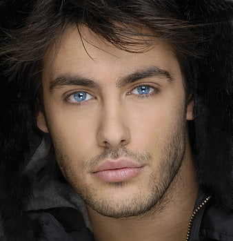 Close-up portrait of handsome man with blue eyes and beard