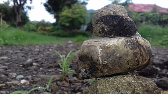 Stacked stones in nature with blurred green background