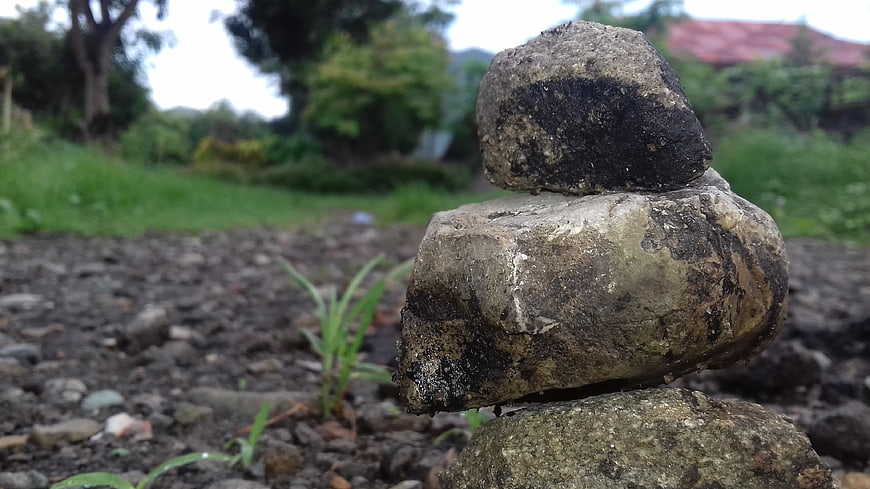 Stacked stones in nature with blurred green background