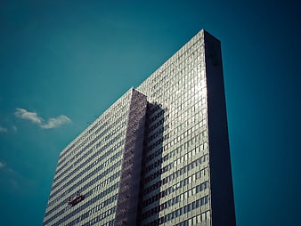 Modern Glass Skyscraper Against Blue Sky