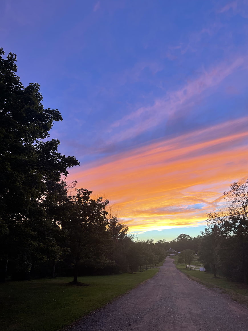 Vibrant Sunset Sky Over Rural Gravel Road