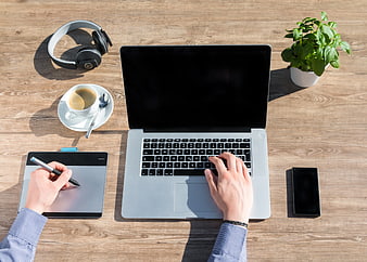 Top View of Modern Workspace with Laptop and Drawing Tablet