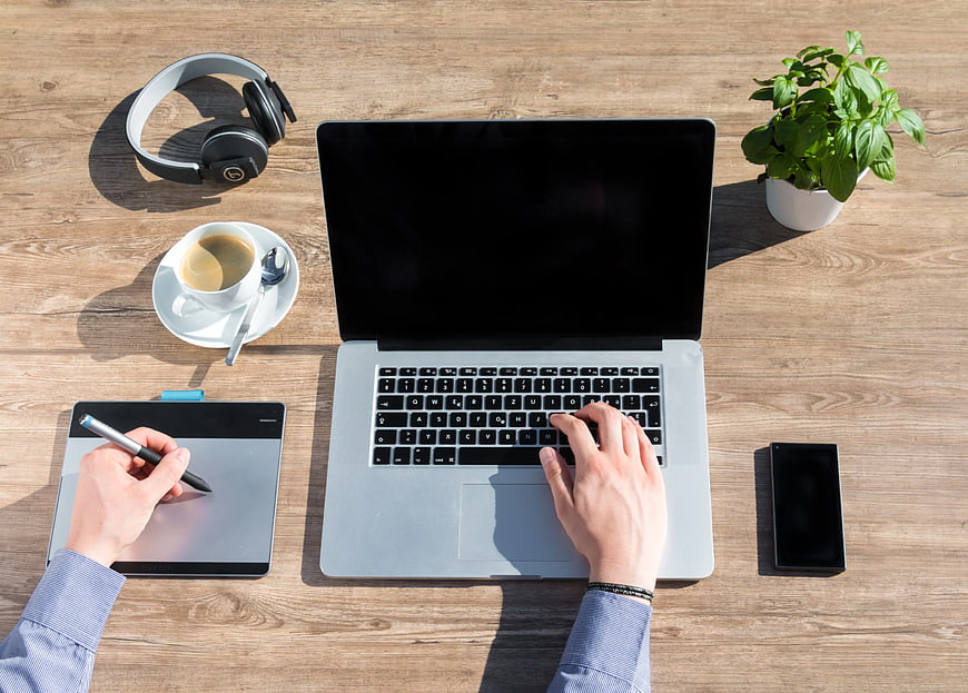 Top View of Modern Workspace with Laptop and Drawing Tablet