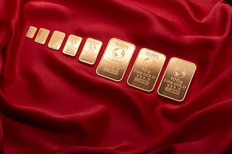 Gold bars on red silk luxury background