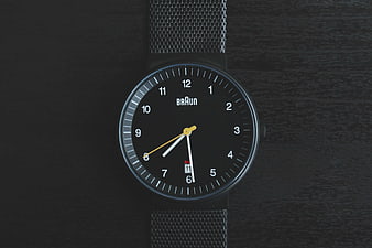 Black Braun Analog Watch on Dark Wood Surface