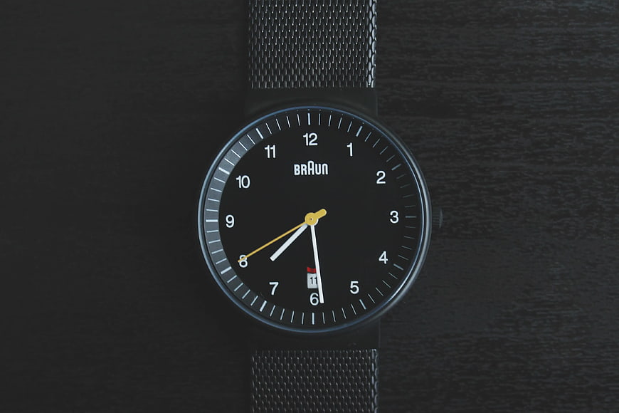 Black Braun Analog Watch on Dark Wood Surface