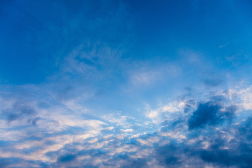 Blue Sky with Fluffy White Clouds Background
