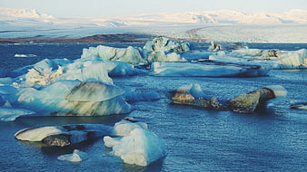 Glacial Icebergs Floating in Blue Lagoon Water