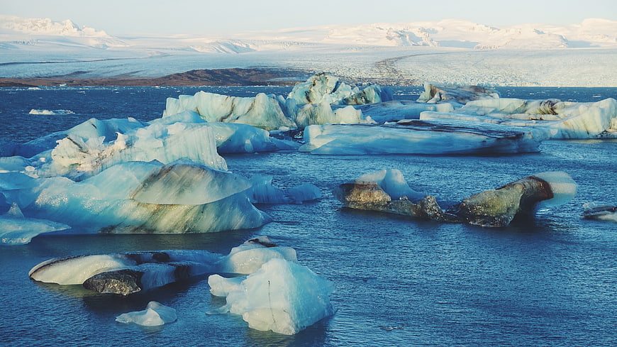 Glacial Icebergs Floating in Blue Lagoon Water