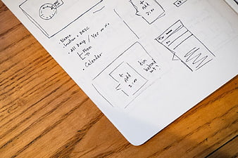 Hand-drawn UX wireframe sketch on notebook paper