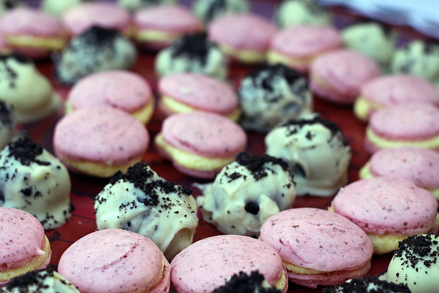 Close-up of pink macarons and white chocolate truffles