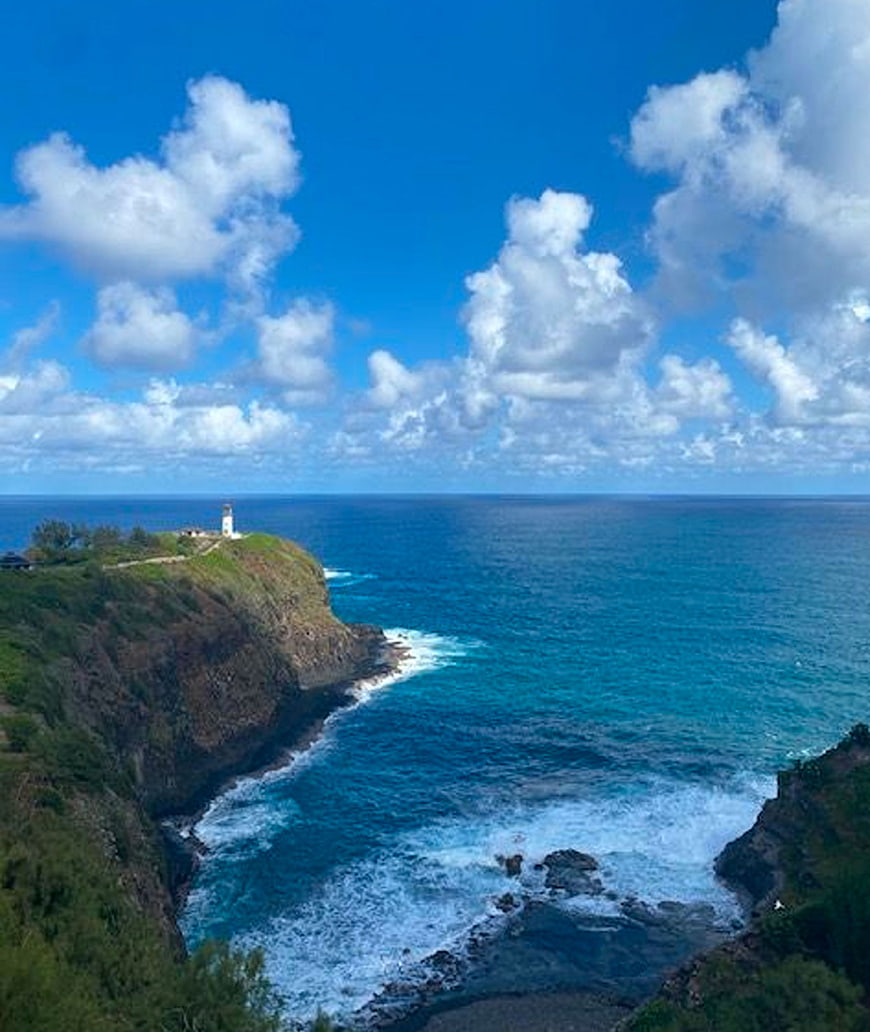 Lighthouse on Cliff Overlooking Blue Ocean