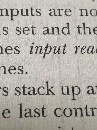 Close-up of printed text on textured paper background