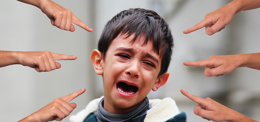 Crying Boy Surrounded by Pointing Fingers Symbolizing Bullying