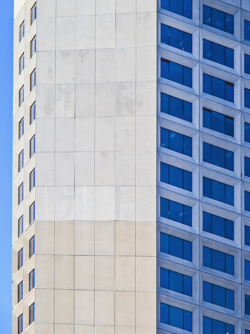 Modern Office Building Corner with Blue Windows and Concrete Facade