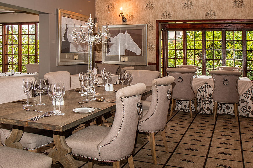 Elegant rustic dining room with wooden table and upholstered chairs