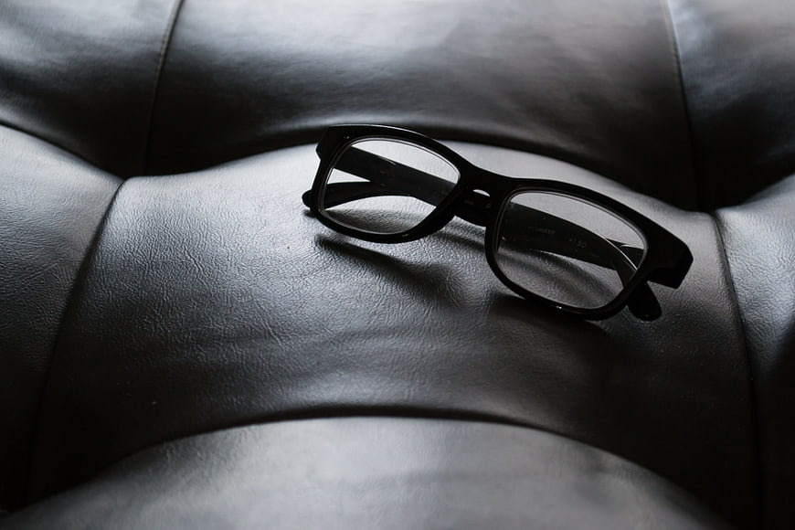 Black Glasses on Leather Couch