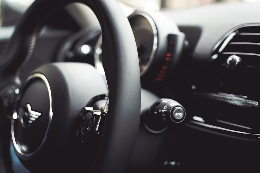 Close-up of Mini Cooper steering wheel and dashboard interior