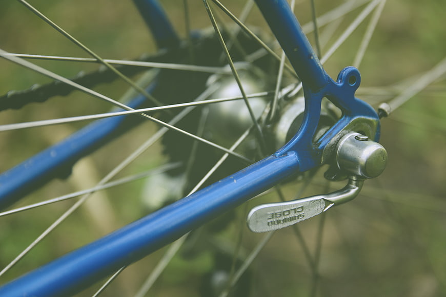 Close-up of Blue Bicycle Rear Wheel and Shimano Brake