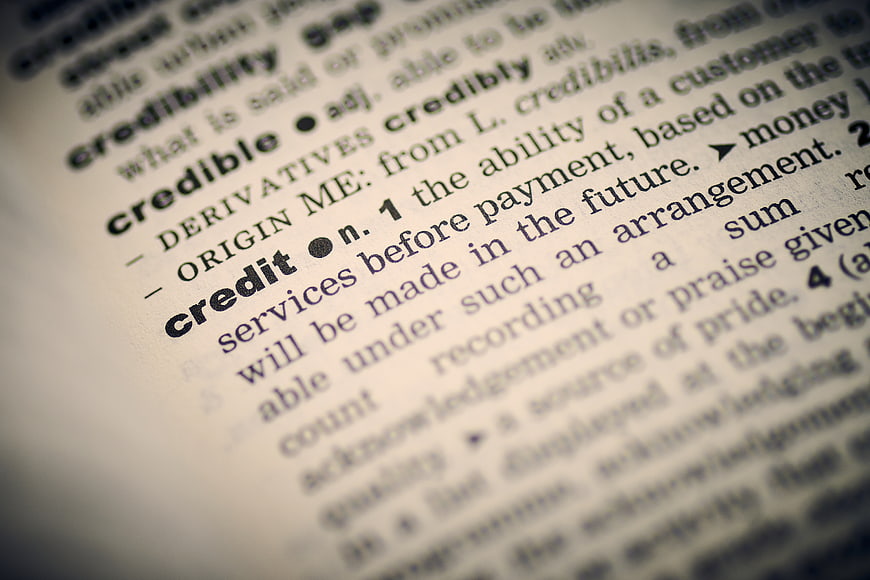 Close-up of dictionary definition for the word credit