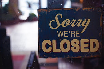 Vintage Blue Sorry We're Closed Sign on Glass Door