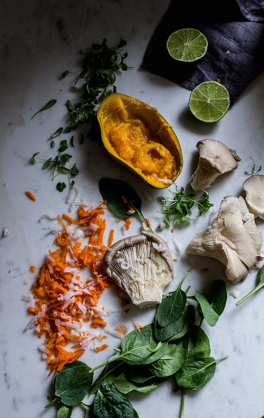 Overhead view of fresh vegan bao bun ingredients on marble