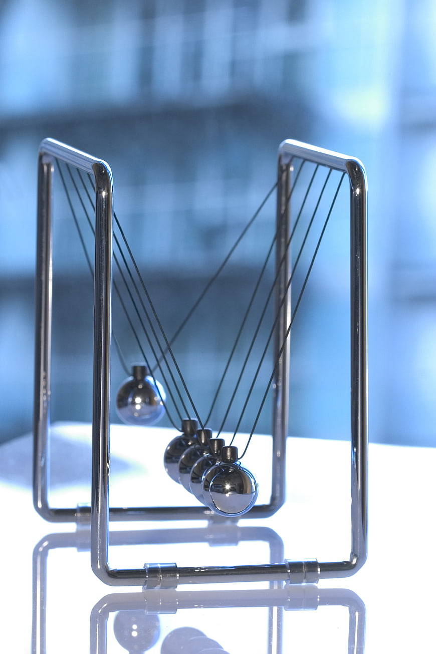 Newton's Cradle Physics Concept with Blue Background