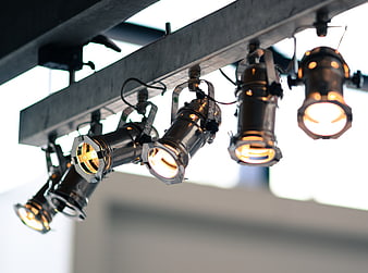 Industrial track lighting with warm spotlights on ceiling