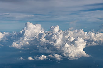 Aerial View of Fluffy White Cumulus Clouds Against Blue Sky