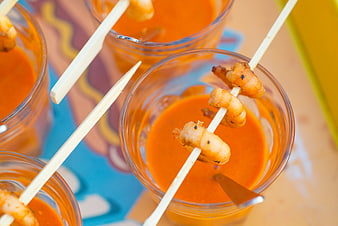 Overhead view of shrimp skewers in orange cocktail sauce