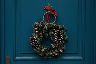 Christmas Wreath with Pine Cones on Blue Door