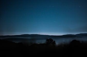 Misty Mountain Landscape at Night with Stars and Fog
