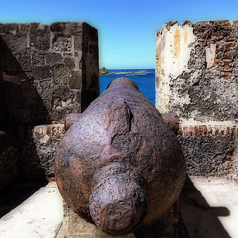 Rusty Cannon in Historic Fort Pointing to Blue Ocean