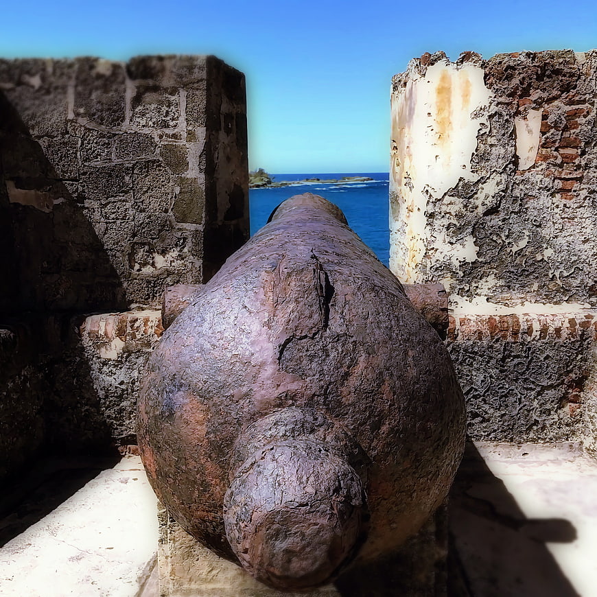 Rusty Cannon in Historic Fort Pointing to Blue Ocean