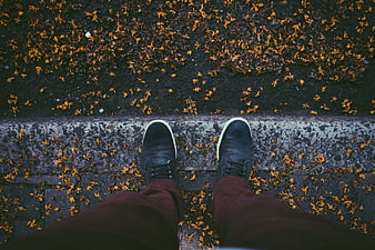 First Person View of Feet on Autumn Leaves