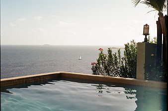 Luxury Infinity Pool Overlooking Ocean with Sailboat