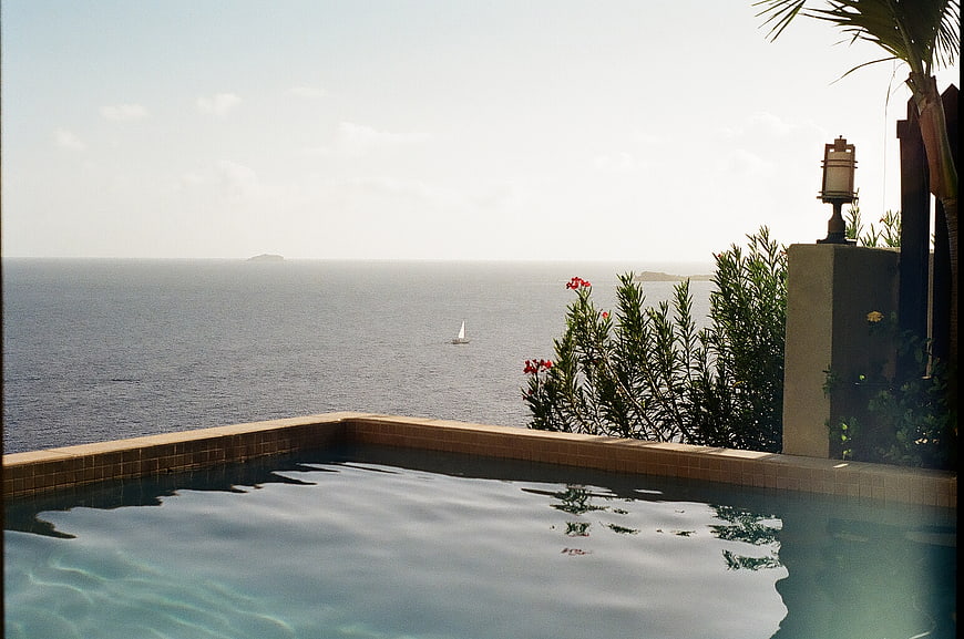 Luxury Infinity Pool Overlooking Ocean with Sailboat