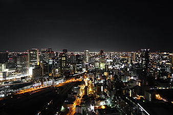 Tokyo Cityscape at Night with Illuminated Skyscrapers and Urban Lights