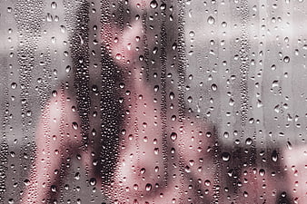 Sensual Silhouette of Woman Behind Rainy Glass